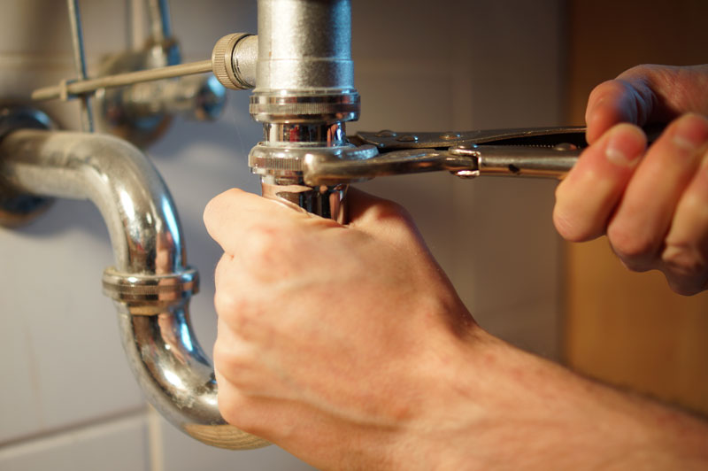 plumber tightening faucet 